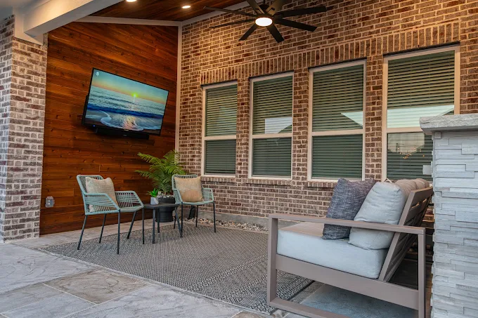 Covered patio with shingle roof and outdoor living area