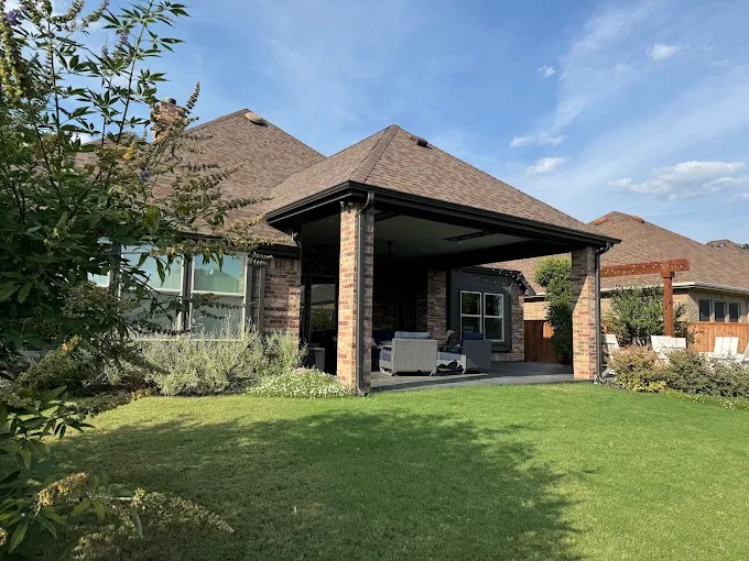Hip shingle roof over a covered back patio